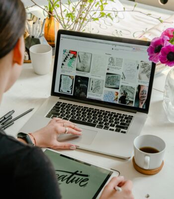 Virtual assistant reviewing terms of service on a laptop at home office desk